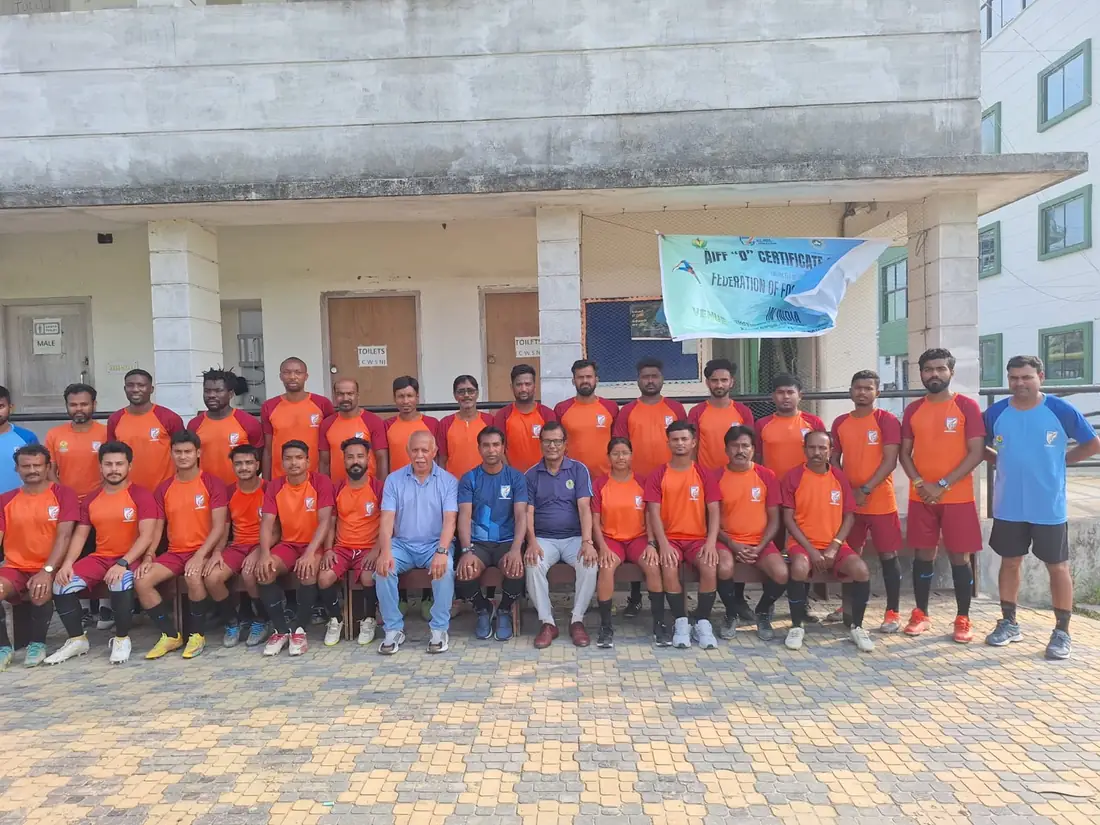 An FFCI coach instructing young players during a training session.